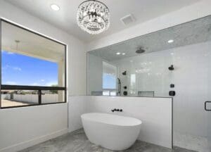 Luxury master bathroom with chandelier and walk-in shower in custom home Queen Creek Arizona