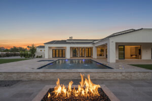 Luxury custom home with pool, fire feature and outdoor living in Paradise Valley Arizona at sunset